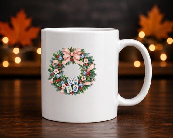 Festive mahjong tile wreath printed on the front of a white ceramic mug.