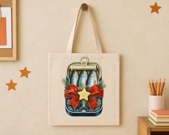 Festive sardine tin with red bow illustration centred on a natural tote bag.