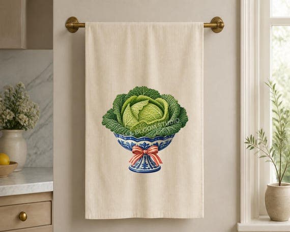 Savoy cabbage in a blue bowl design aligned centrally on an ivory linen tea towel.